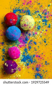 Celebrate indian festival holi, Multicolors ball on yellow background - Shutterstock ID 1929725549