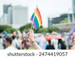 Celebrate in pride month festival. Pride movement transgender hand holding LGBTQ rainbow flag for freedom. Gatherings of friends in parade communities celebrating LGBTQ+ causes.