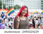 Celebrate in pride month festival. Pride movement transgender asian lesbian LGBT holding rainbow flag for freedom. Gatherings of friends in parade communities celebrating LGBTQ+ causes.