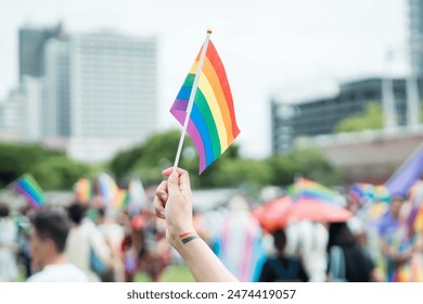 Celebrate in pride month festival. Pride movement transgender hand holding LGBTQ rainbow flag for freedom. Gatherings of friends in parade communities celebrating LGBTQ+ causes.