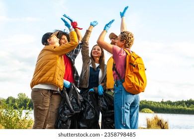 Celebrate the spirit of environmental stewardship and camaraderie in this dynamic image. A diverse group of young volunteers from different ethnic backgrounds unite to clean up the forest. With high - Powered by Shutterstock