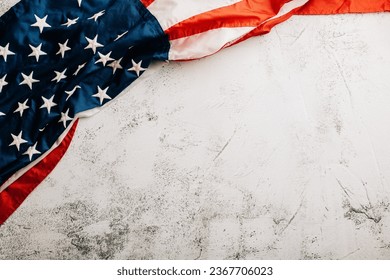 Celebrate Veteran's Day with a vintage US flag, representing American honor, pride, and unity. Patriotic stars and stripes convey the importance of government. isolated on cement background - Powered by Shutterstock