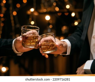 Celebrate whiskey on a friendly party in  restaurant - Powered by Shutterstock