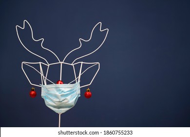 Celebrating Christmas During Coronavirus Pandemic. Reindeer Wearing Medical Mask.