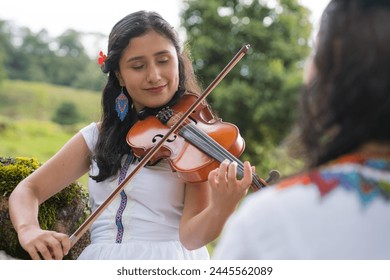 Celebrating Colombian heritage, women play traditional music in natural surroundings. Her presence evokes a sense of reverence for tradition and the wisdom of age. She is playing instruments  - Powered by Shutterstock