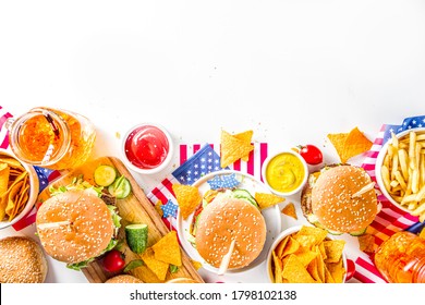 Celebrating Independence Day, July 4. Traditional American Memorial Day Patriotic Picnic with burgers, french fries and snacks, Summer USA picnic and bbq concept, White concrete background