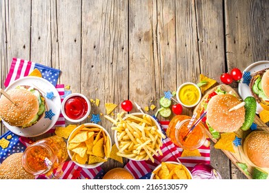 Celebrating Independence Day, July 4. Traditional American Memorial Day Patriotic Picnic With Burgers,  French Fries And Snacks, Summer USA Picnic And Bbq Concept, Old Wooden Background 