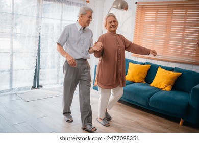 Celebrating Retirement: Elderly Couple Embrace Love and Happiness at Home, Fun-filled Life of Dancing, Smiling, and Bonding Together, Cherishing Family and Romance in Their Golden Years - Powered by Shutterstock