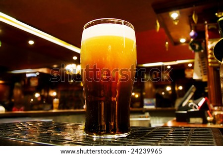 Celebrating Saint Patrick - Irish black beer shot inside a Dublin pub.