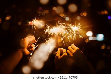 Celebrating with sparklers in the night - Powered by Shutterstock