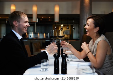 Celebrating A Special Occasion. Cropped Shot Of A Couple Having Dinner In A Restaurant.