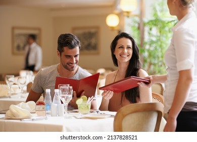 Celebrating Their Anniversary. A Happy Young Couple On A Date At A Fancy Restaurant.