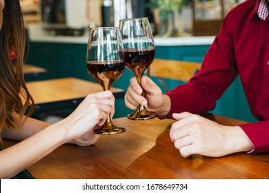Celebrating in Valentine day. Couple toasting red wine glass. Dating concept.