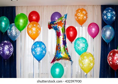 Celebration Of 1st Year Birthday. One Year Balloon Sign. Birthday Party With Many Colorful Balloons