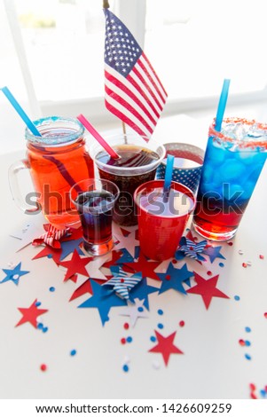 celebration, anniversary and national holidays concept - drinks in cups and glasses on table at american independence day party