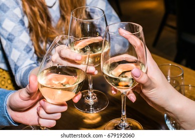 Celebration. Close Up People Holding Glasses Of White Wine Making A Toast