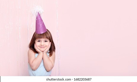 celebration concept. Kid girl dressed festive,party clothes on a pink background