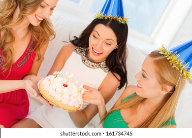 Celebration, Food, Friends, Bachelorette Party, Birthday Concept - Three Smiling Women Wearing Blue Hats Holding Cake With Candles