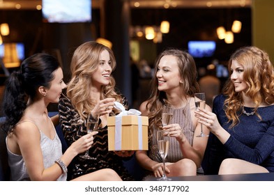 Celebration, Friends, Bachelorette Party, Birthday And Holidays Concept - Happy Women With Champagne Glasses And Gift Box At Night Club