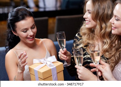 Celebration, Friends, Bachelorette Party, Birthday And Holidays Concept - Happy Women With Champagne Glasses And Gift Box At Night Club