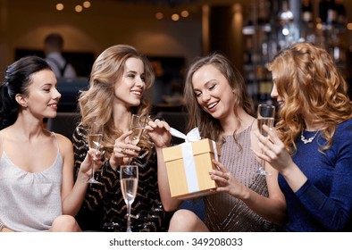 Celebration, Friends, Bachelorette Party, Birthday And Holidays Concept - Happy Women With Champagne Glasses And Gift Box At Night Club