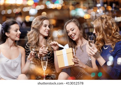 Celebration, Friends, Bachelorette Party, Birthday And Holidays Concept - Happy Women With Champagne Glasses And Gift Box At Night Club