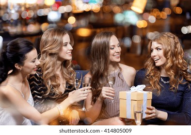 Celebration, Friends, Bachelorette Party, Birthday And Holidays Concept - Happy Women With Champagne Glasses And Gift Box At Night Club