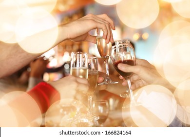 Celebration. Hands holding the glasses of champagne and wine making a toast.