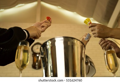 Celebration Hands Pulling A Christmas And New Year Pop Up Cracker With Champagne Glasses