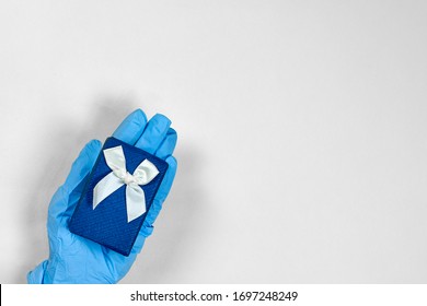 Celebration holiday, birthday in hospital. Doctor giving giftbox to patient or Healthcare worker receiving present from patient. Celebrating birthday in quarantine during covid-19 pandemic - Powered by Shutterstock