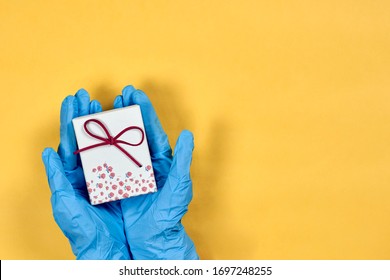 Celebration holiday, birthday in hospital. Doctor giving giftbox to patient or Healthcare worker receiving present from patient. Celebrating birthday in quarantine during covid-19 pandemic - Powered by Shutterstock