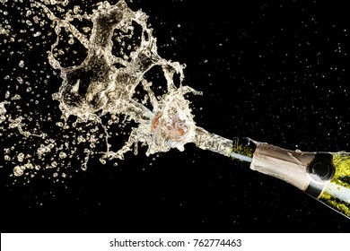Celebration and holiday theme. Champagne splashes on black background.