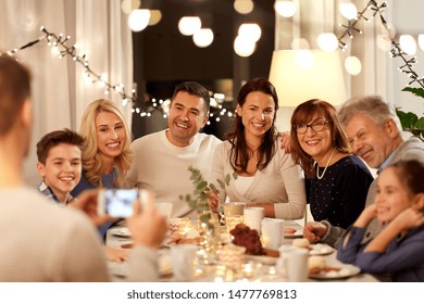 Celebration, Holidays And People Concept - Happy Family Having Tea Party And Photographing By Smartphone At Home