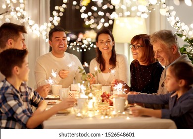 Celebration, Holidays And People Concept - Happy Family With Sparklers Having Tea Party At Home