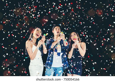 Celebration Party Group Of Asian Young People Holding Confetti Happy And Funny Concept