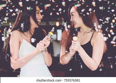 Celebration Party Group Of Two Asian Young  Women People Holding Confetti Happy And Funny Concept. In 2018 New Year Holiday.