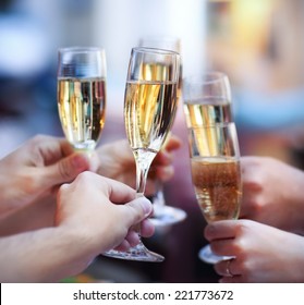 Celebration. People Holding Glasses Of Champagne Making A Toast