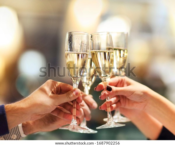 Celebration. People holding glasses of\
champagne making a toast. Champage with blurred\
background