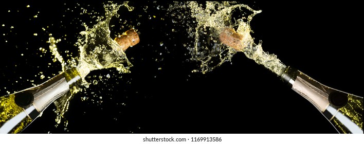 Celebration Theme With Explosion Of Splashing Champagne Sparkling Wine Bottles On Black Background