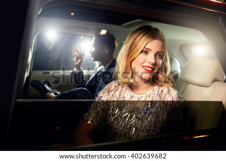 Celebrity couple in back of a car, photographed by paparazzi
