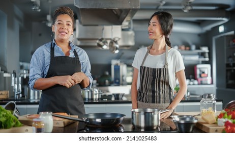 Celebrity TV Cooking Show Kitchen: Asian And Black Female Chefs Talk, Teach How To Cook Food. Online Video Courses, Television Program Presenters. Preparation Of Healthy Traditional Fusion Dish Recipe