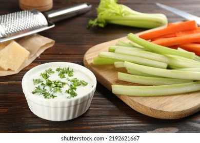 Celery And Carrot Sticks With Dip Sauce On Wooden Table, Closeup