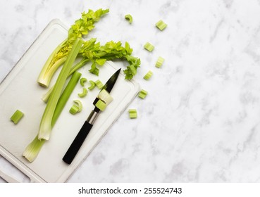 Celery On A Cutting Board On Marble Background