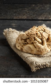 celery root and burlap on dark wooden background.