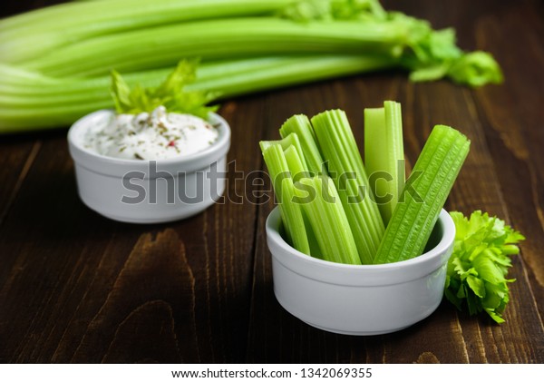 Celery\
sticks in ceramic bowl with greek yogurt\
sauce