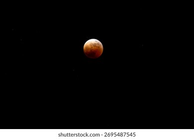 Celestial Spectacle: Blood Moon Eclipse Against Starry Night