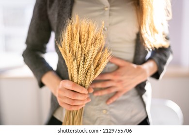Celiac Disease And Gluten Intolerance. Women Holding Spikelet Of Wheat - Shutterstock ID 2129755706