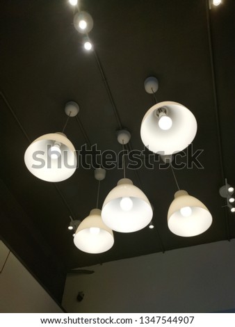 Celing lighting consists of five hanging lamps. 