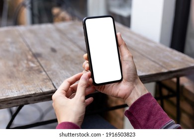 cell phone blank white screen mockup.woman hand holding texting using mobile on desk at office.background empty space for advertise.work people contact marketing business,technology - Shutterstock ID 1916503823