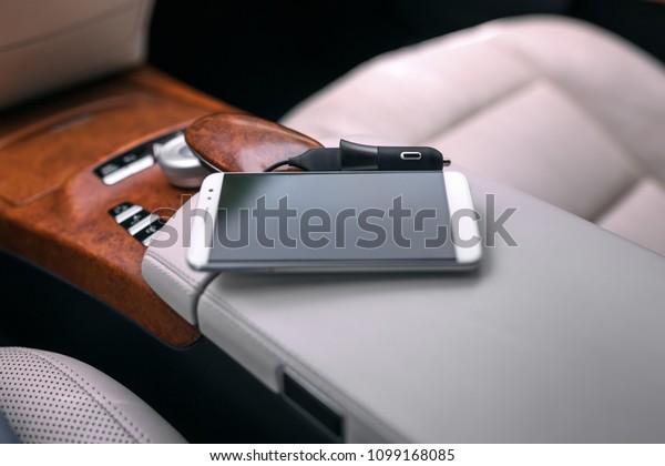 Cell\
phone car charger in the interior of a luxury\
car